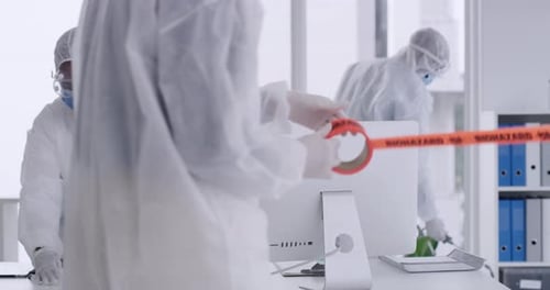 Adults in Protective Suits and Biohazard Tape