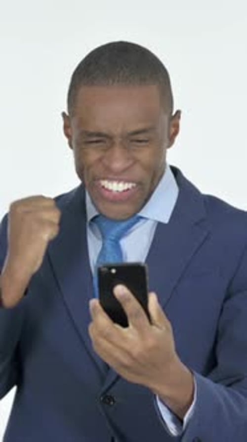 Excited Man in Suit Celebrates Good News on Phone