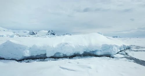 Massive Snow Covered Iceberg in Frozen Ocean
