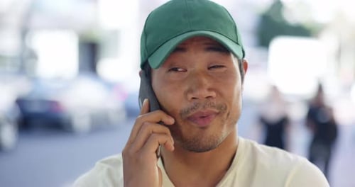 4k video footage of a young man talking on a cellphone while out in the city