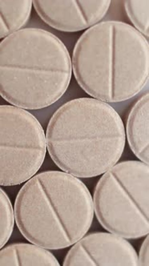 Medical Brown Pills Placed on Rotating Table Close Up Vertical Video