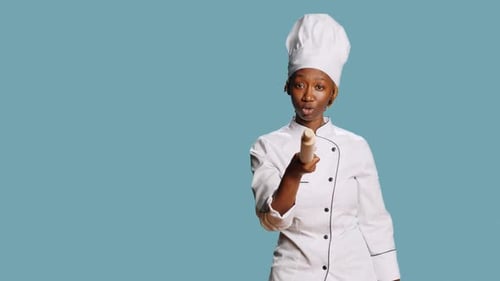 African American Chef Pointing at Camera with Wooden Pin