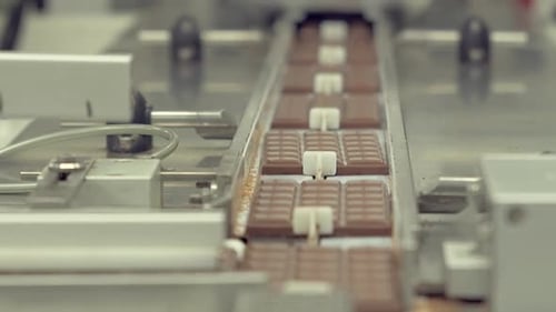 chocolate bars change the direction of movement on the conveyor line