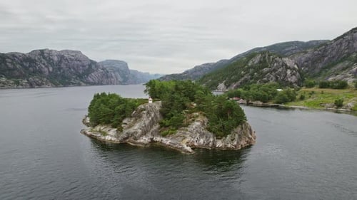 Arc Shot Of Small Island Amidst Rugged Norwegian Mountains