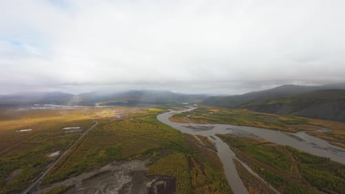 Aerial View of River Valley and Distant Mountains