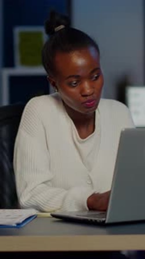 Woman working at laptop appears stressed