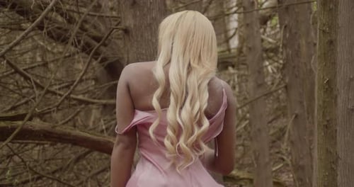 Black Girl Sitting In The Forest Facing Away From Camera, Shaking Hair Medium Shot Slow Motion 60fps