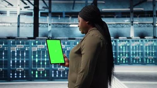 Software Developer at Work Using Green Screen Tablet in Data Center