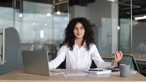 Businesswoman Meditates at Desk Finding Calm and Mindfulness in the Office