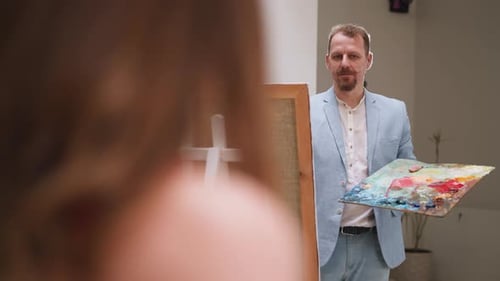 Artist with Palette Standing near Canvas on Easel