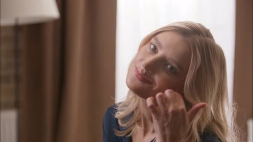 Smiling Blonde Woman Posing Indoors