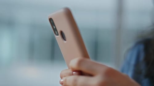 Woman Smiling While Holding Cell Phone Device