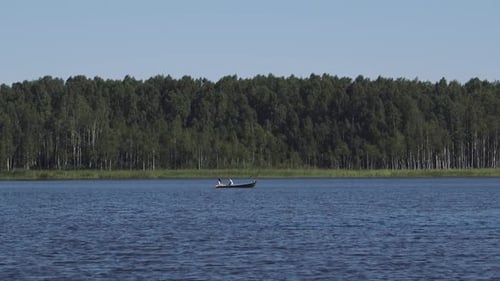 family is rowing boat on a very beautiful lake