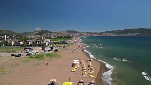 Drone view of Dikili beach and colorful sun loungers