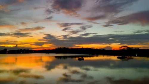 The beautiful sunset over the calm waters of the lake makes for a perfect view