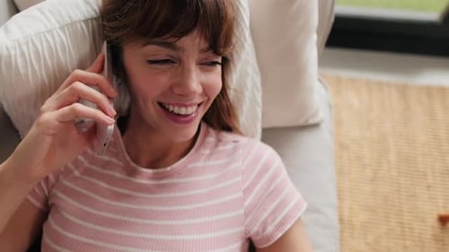 Woman Laying on Couch Talking on Cell Phone
