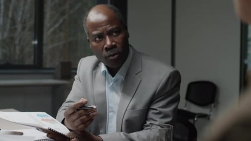 Man in Suit Talking in Workplace