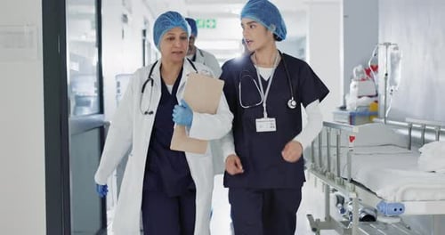 Doctors, nurses and women walking, talking and planning healthcare, clinic management
