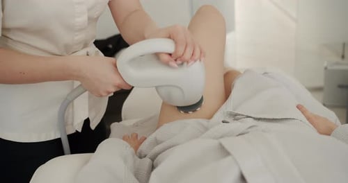 Woman Receiving Leg Treatment in Clinic