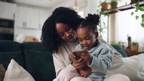Mother and Child Using Phone on Couch