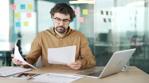 Man Working at Desk in Bright Office