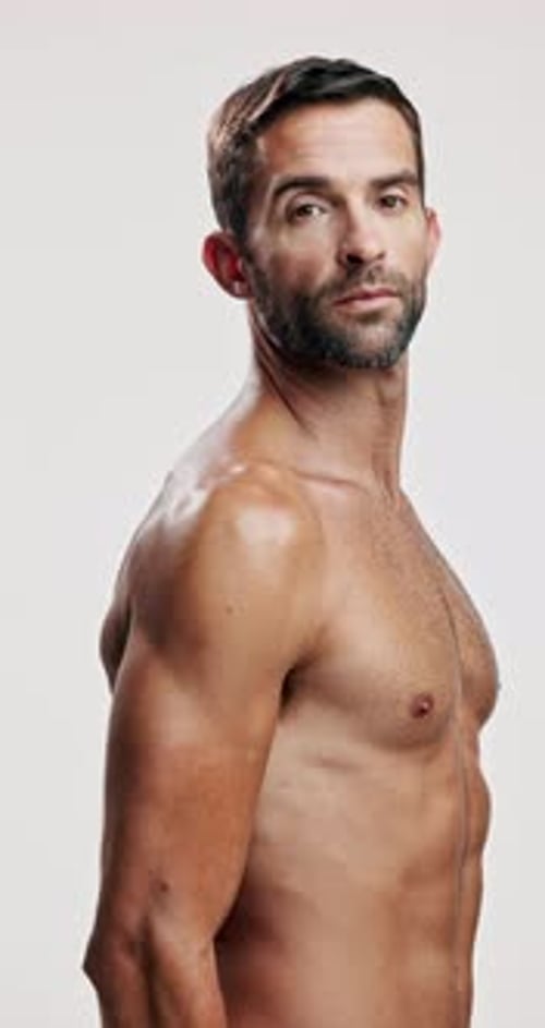 Studio, fitness and face of man, body and bodybuilder with pride for muscles, self care or wellness