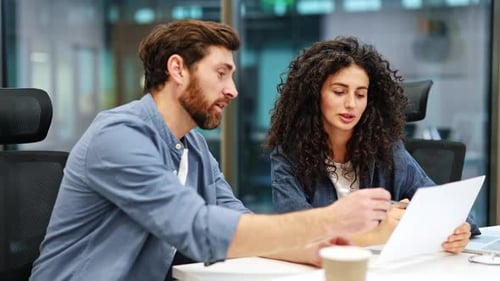 Businesswoman And Male Colleague Shake Hands After Successful Agreement In Office
