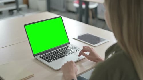 Blonde Woman Using Laptop with Chroma Key Screen