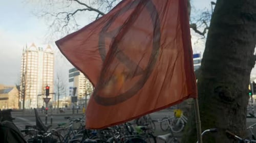 Flag with Peace Symbol Waving in Urban Setting