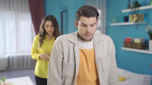 Upset Man Being Comforted by Woman Indoors