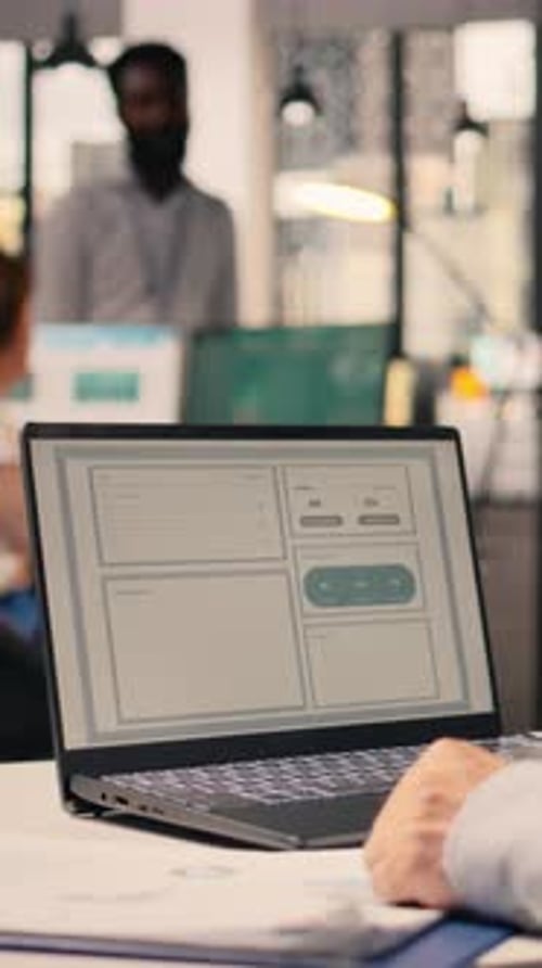 Vertical Video Worker Analyzes Business Intelligence and Monetary Data on Laptop