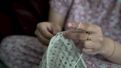 Close-Up Image of Hands Crafting with Crochet Hook and Yarn