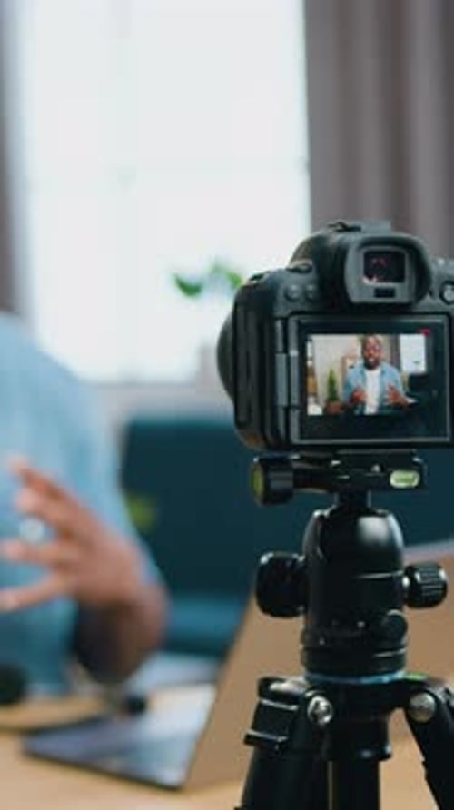 Man Records Video Blog at Home on Camera