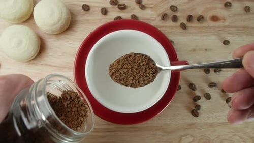 Scooping Instant Coffee Into Mug with Spoon