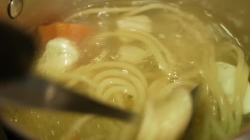 Chef Cooking Chicken Soup with Noodles