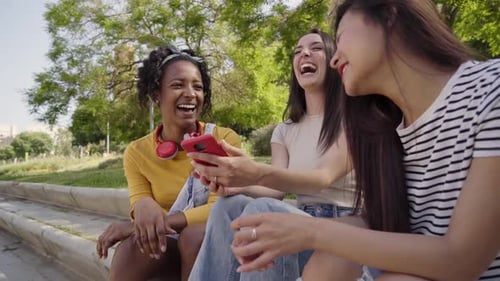 Group of Young Multiracial Happy Women Using Mobile in Park Outdoor Generation z Dating Apps