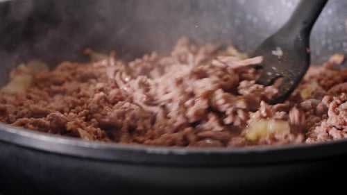 Ground Meat Sizzling in a Pan With Onions