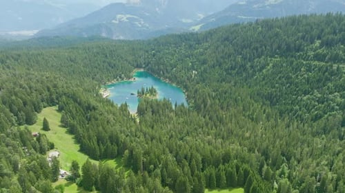 beautiful blue lake in the middle of a large forest