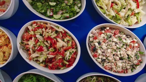 Motion Over Delicious Fresh Salads on Blue Table in Cafe