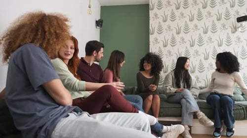 Friends Chatting Together Indoors on Couches