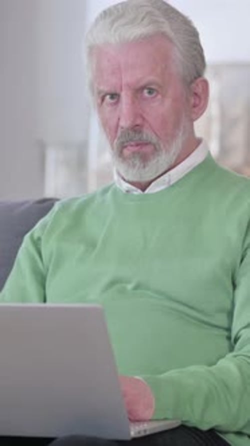Senior Man Working on Laptop at Home