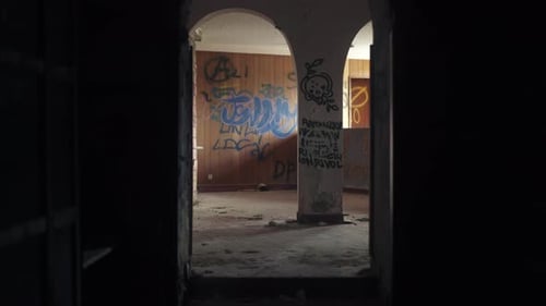 Walking through abandoned derelict building, graffiti and street art on walls