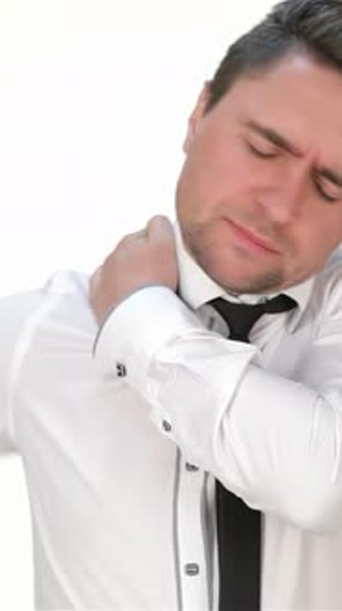 Man Rubbing Neck and Shoulder in Discomfort
