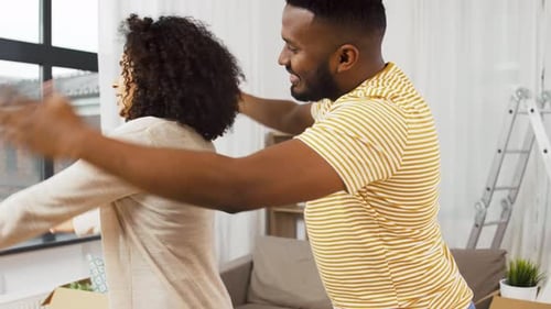 People and Real Estate Concept - Happy Couple Moving to New Home