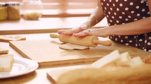 Close up of woman kneaded yeast dough with hand in kitchen at home.