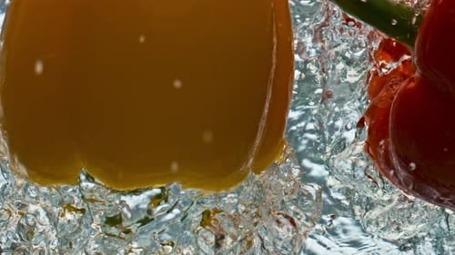 Close Up of Bell Peppers Dropping into Water
