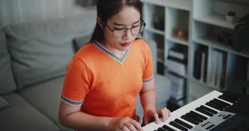 Woman Playing Keyboard in Her Living Room