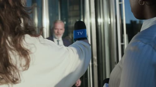 Man Gives Press Conference Surrounded by Reporters