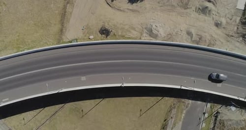 Individual single silver passenger vehicle tracking over new bypass infrastructure.