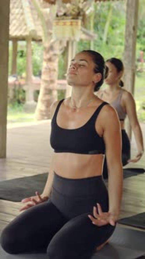 Women Stretch and Practice Yoga Outdoors